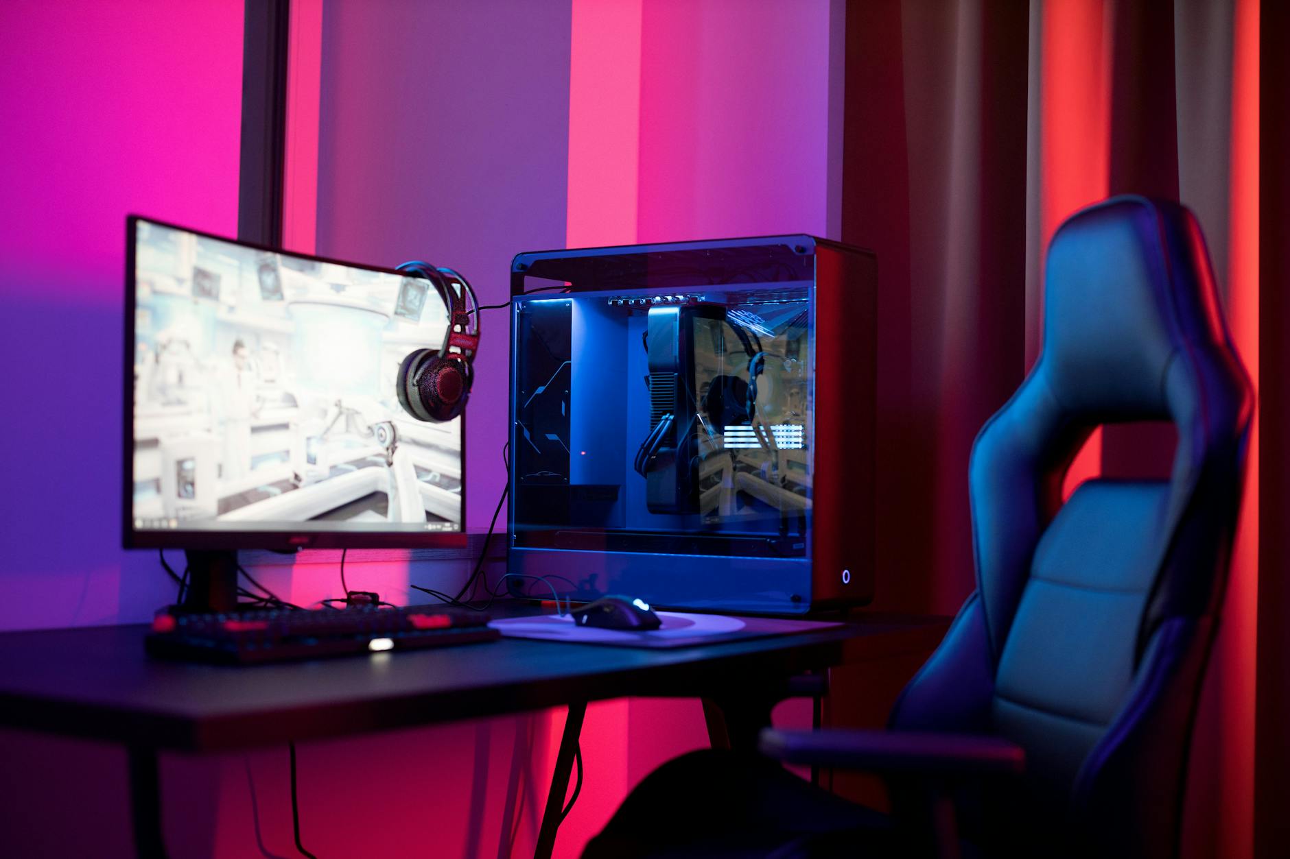 Gaming computer setup with RGB lighting and multiple monitors on desk