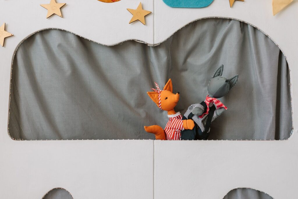 Empty theater stage with dramatic lighting and red curtains before a performance
