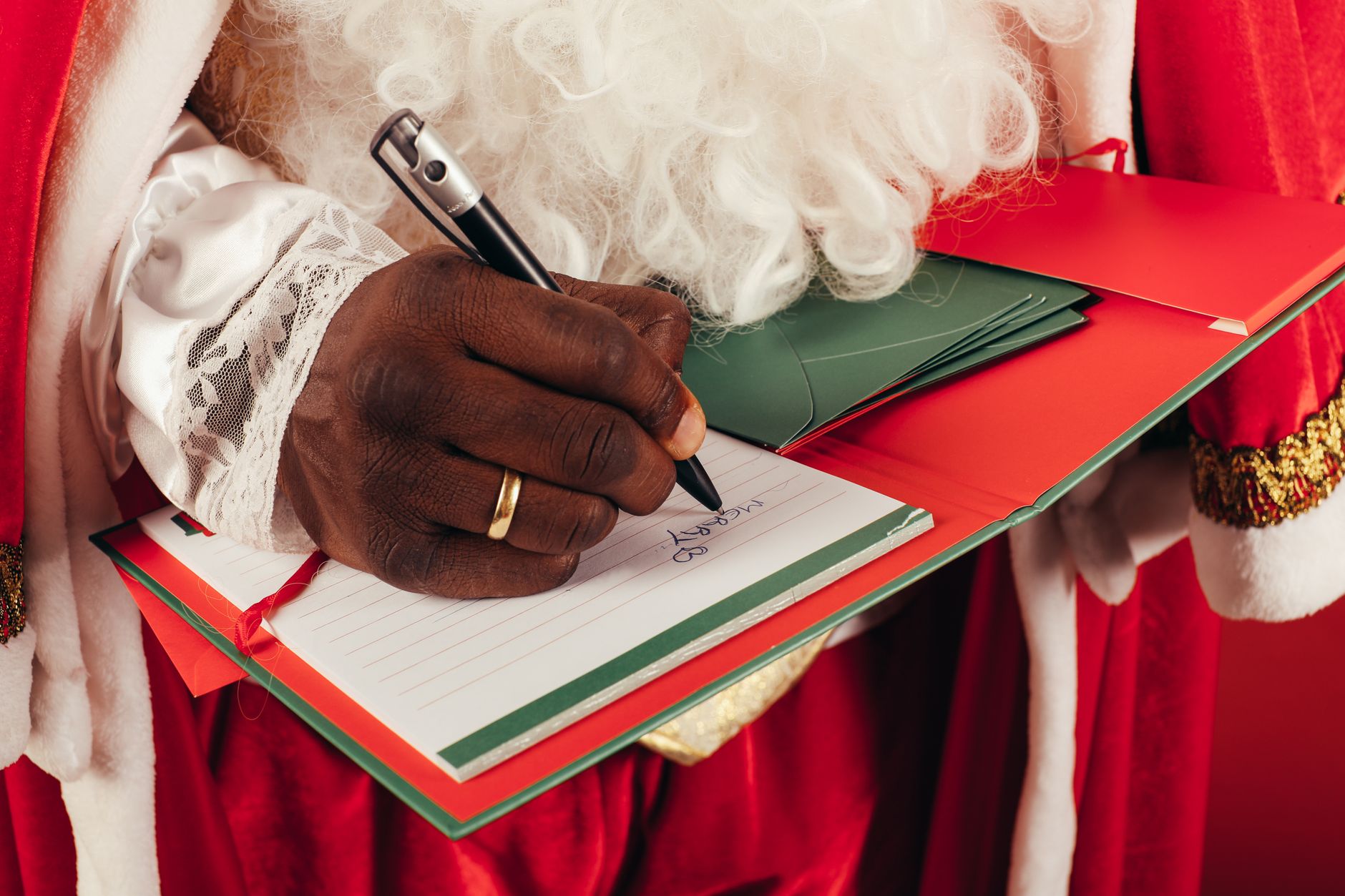 Holiday shopping list with gifts and gaming items on a desk