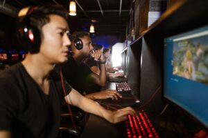 Steam’s Wishlist Algorithm Overhaul Is Burying Midsize Studios A gaming PC setup with a monitor displaying a game library interface