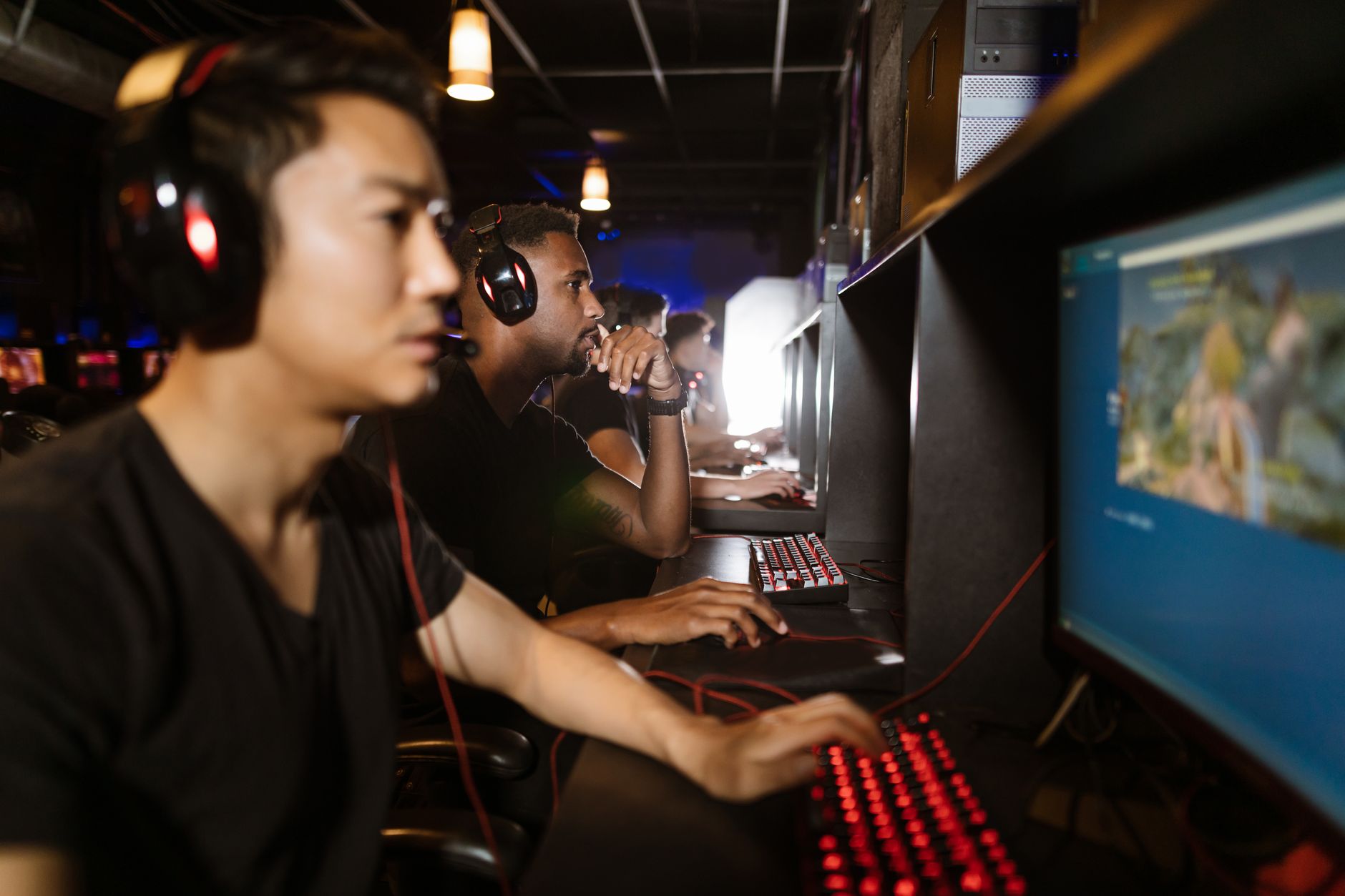 A gaming PC setup with a monitor displaying a game library interface