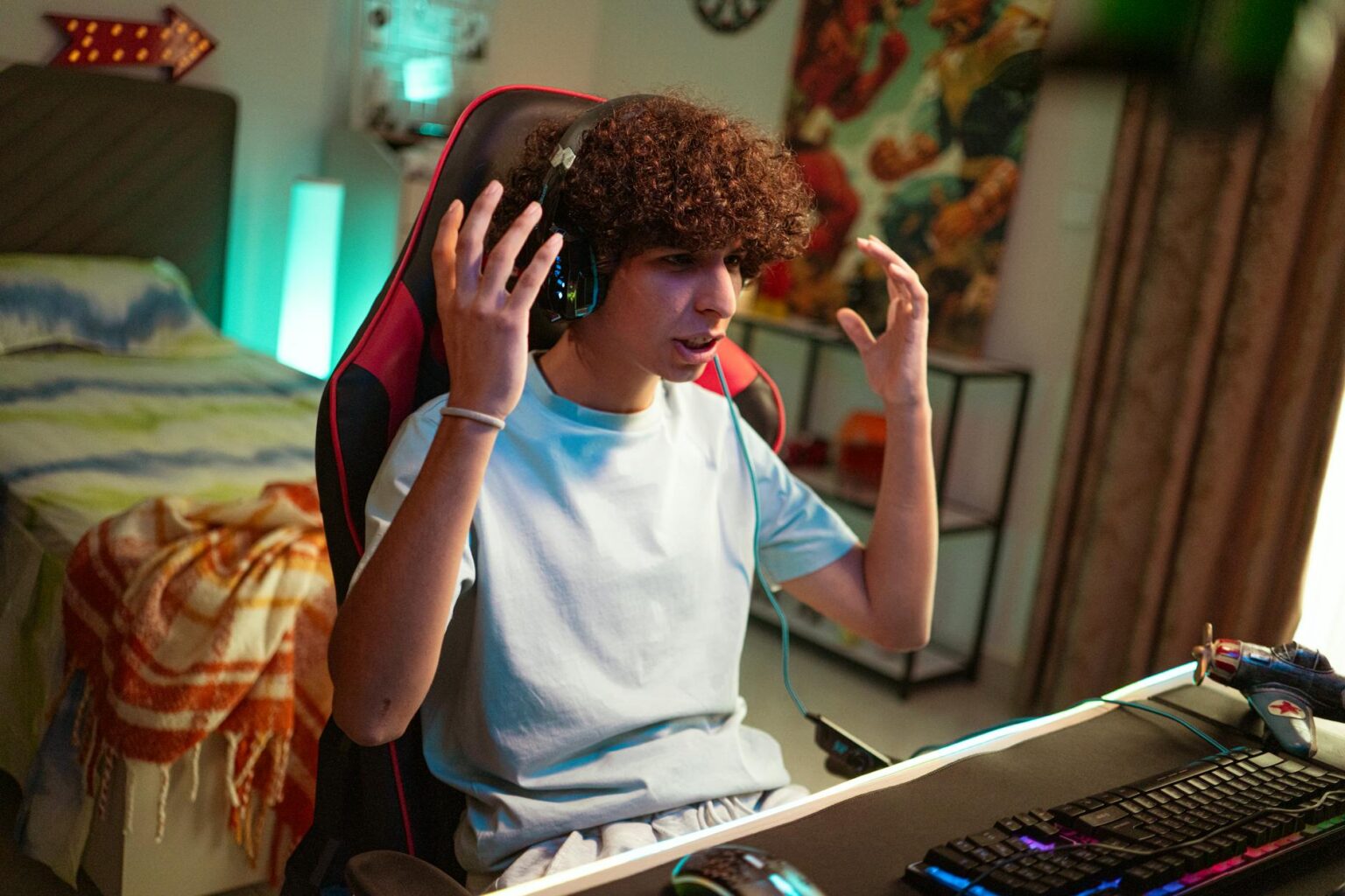 Gaming headset resting on a desk next to a portable game console