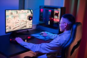 A PC gaming desk setup with monitor and keyboard representing digital game ownership