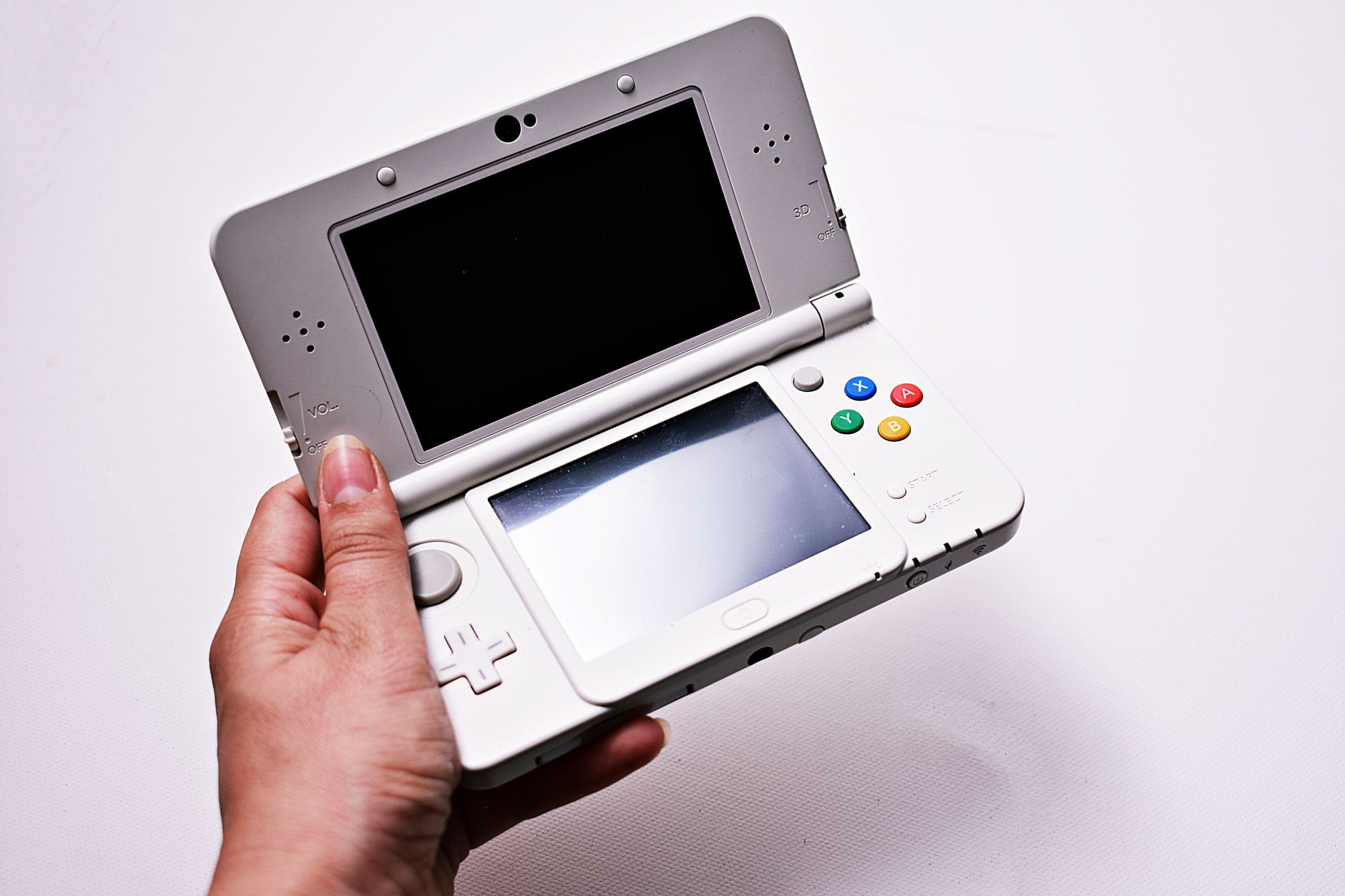 A handheld Nintendo gaming device resting on a flat surface, representing portable gaming culture