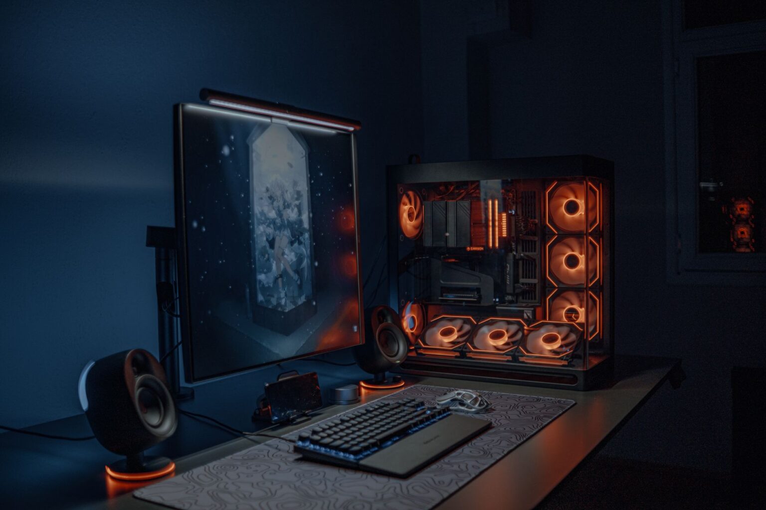 A dark gaming setup with multiple monitors, representing the Halo modding community's workstation environment