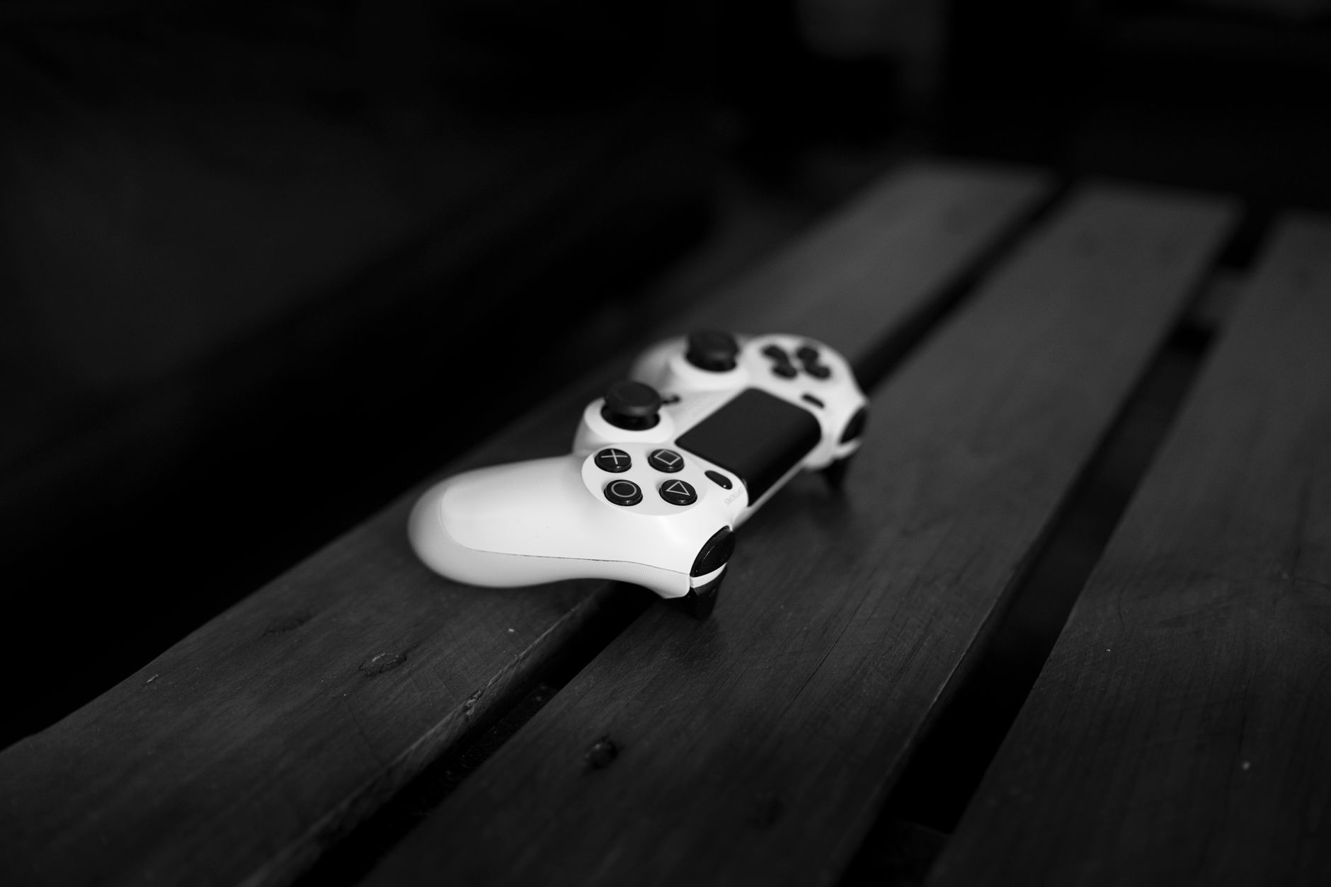 A gaming controller resting on a surface, symbolizing the wait for a new game release