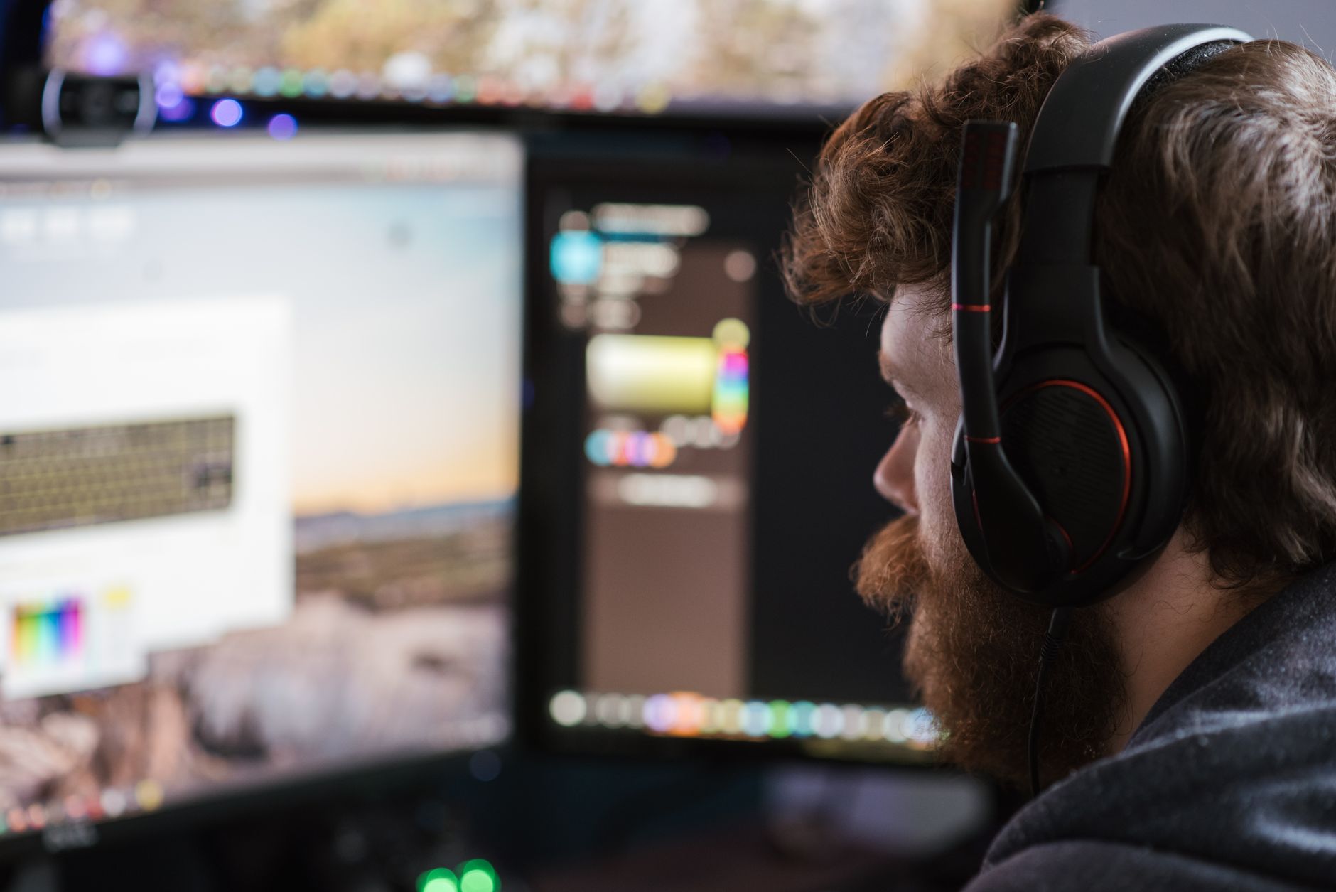 Video game developers working at computer stations in a modern studio environment