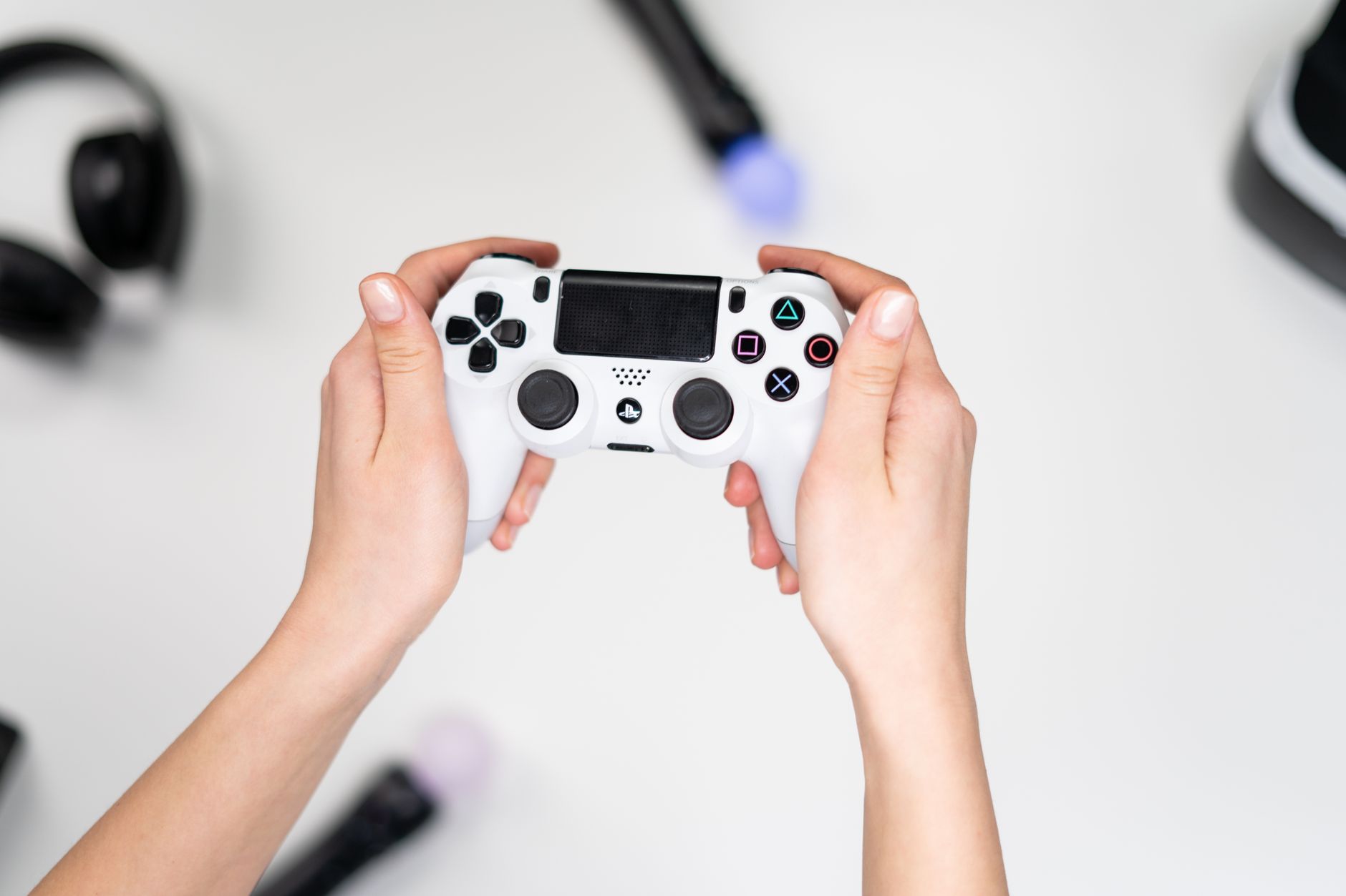 A player holding a game controller while playing on a modern console