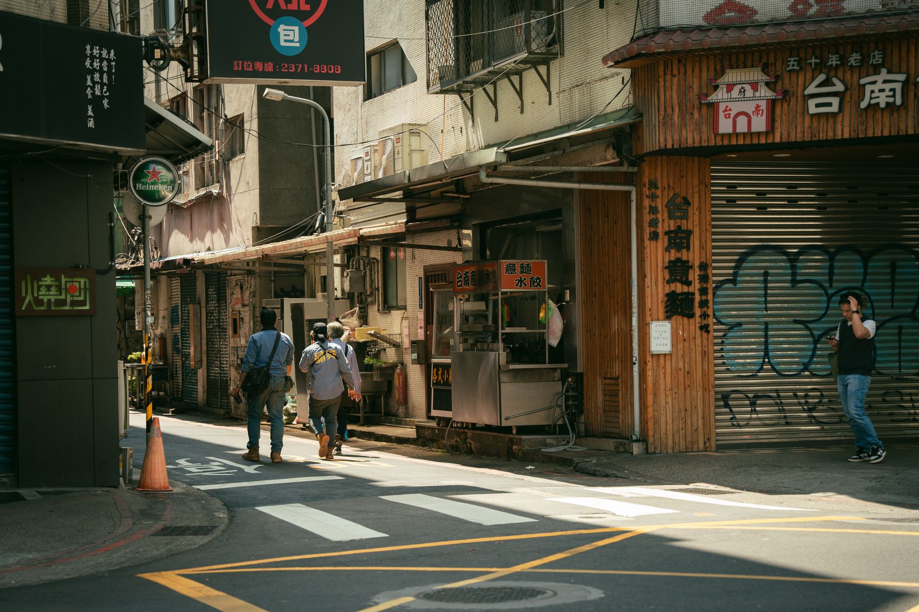 A person exploring a narrow urban street between tall buildings, evoking the vertical city exploration expected in Pokemon Legends Z-A