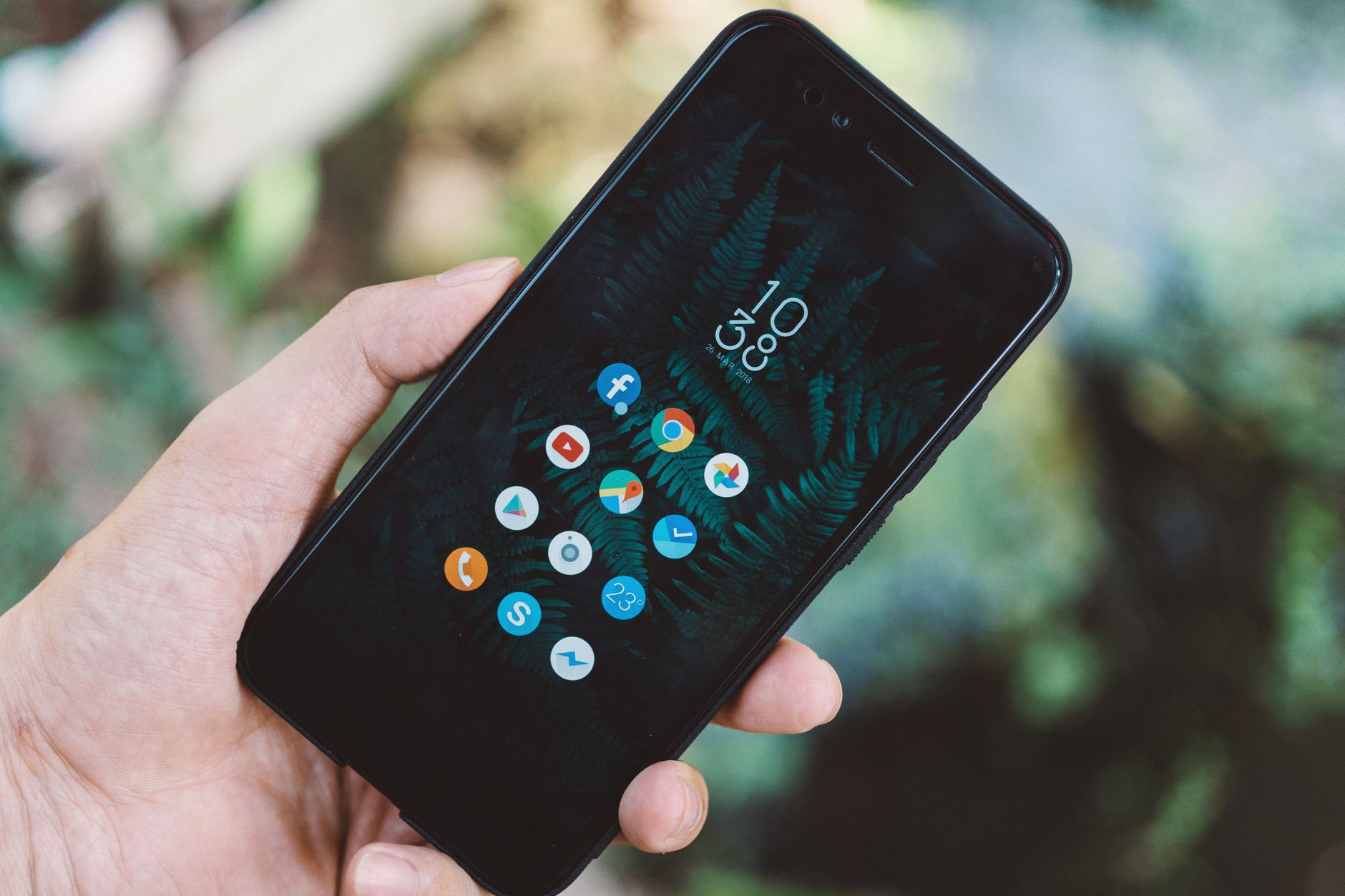 A parent reviewing a parental control app on a smartphone