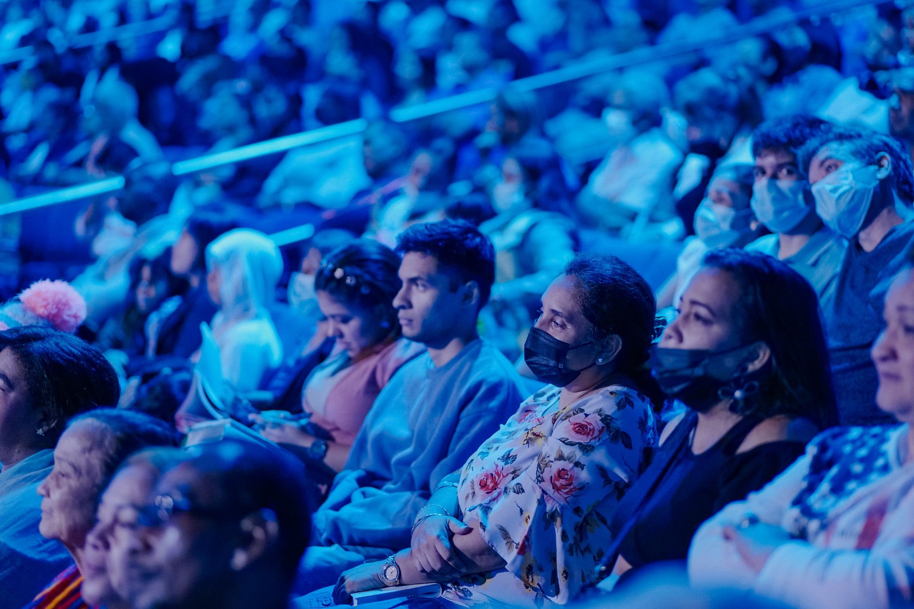 Theater audience watching a live stage performance under house lights