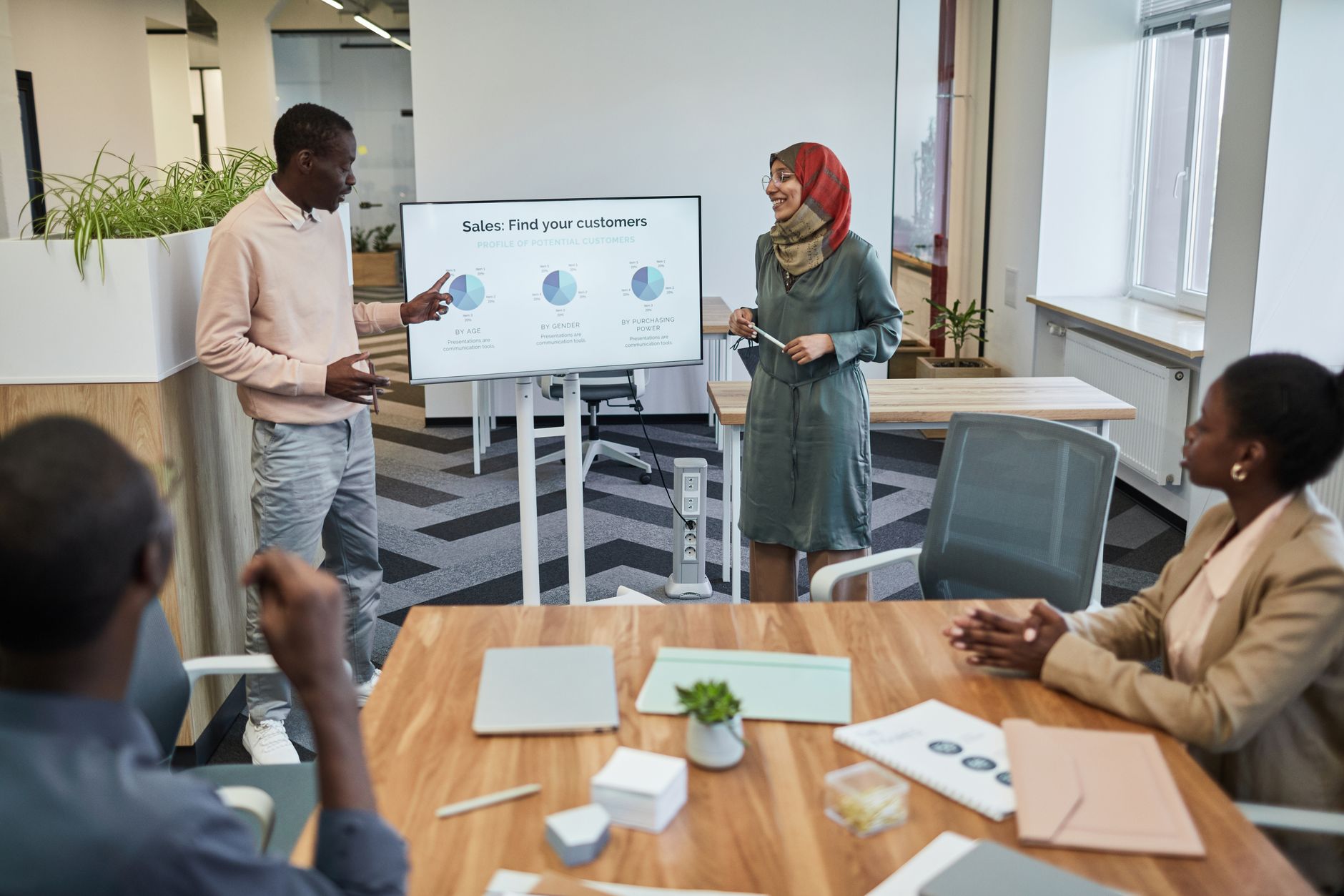A team presenting a pitch in a corporate meeting room setting