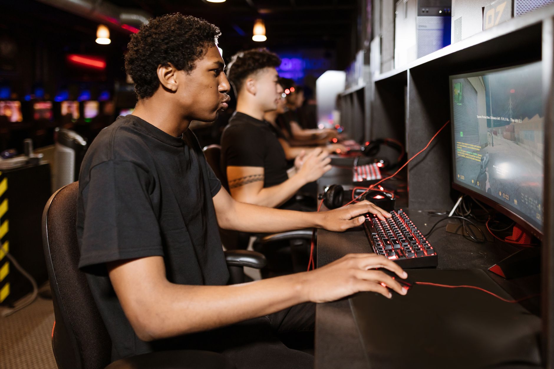 A gamer wearing a headset at a PC gaming station