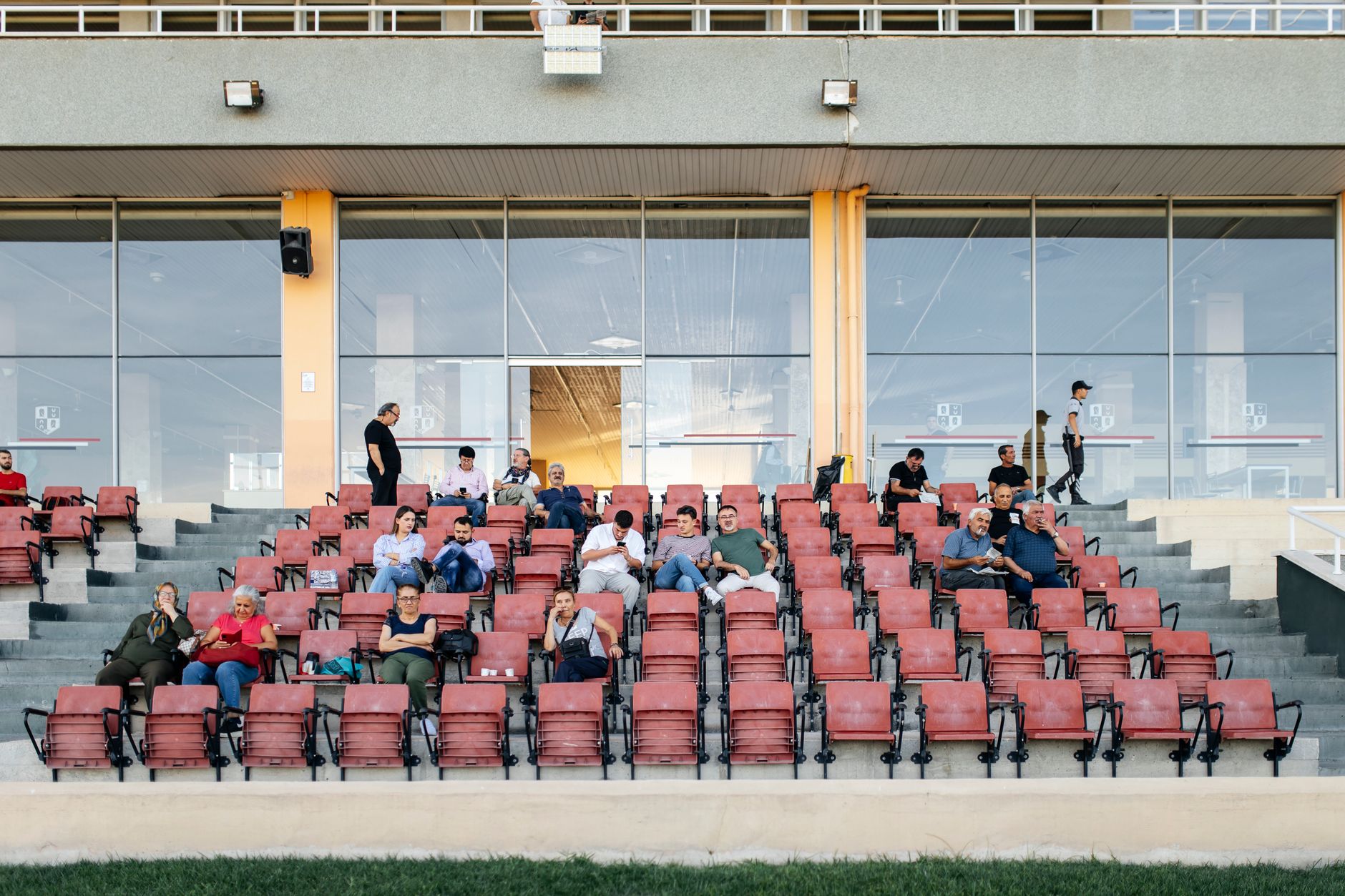 A crowd of people waiting expectantly in a large indoor venue