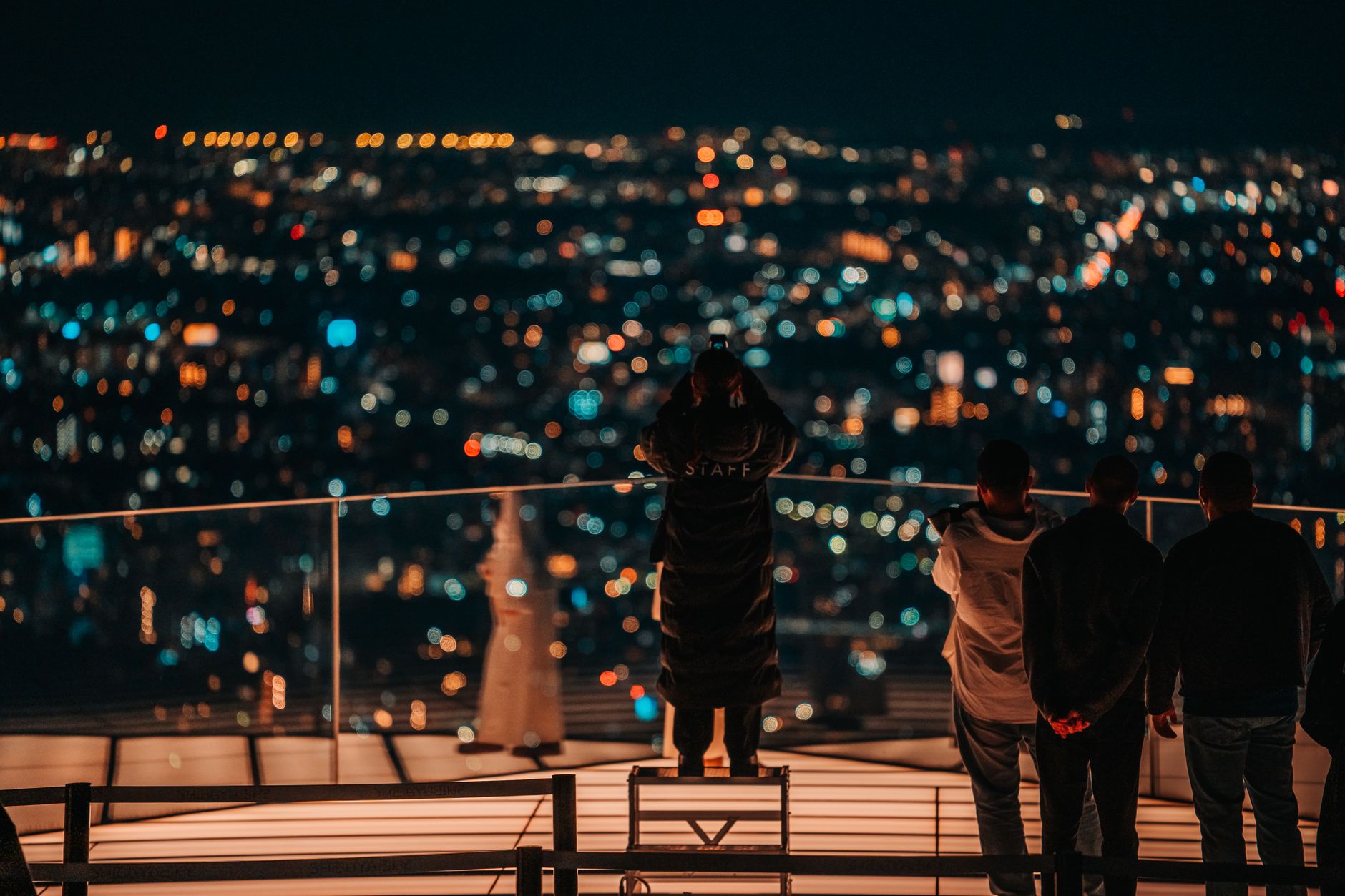 Illuminated city rooftops at night suggesting the layered urban environment at the center of the Pokemon Legends Z-A debate