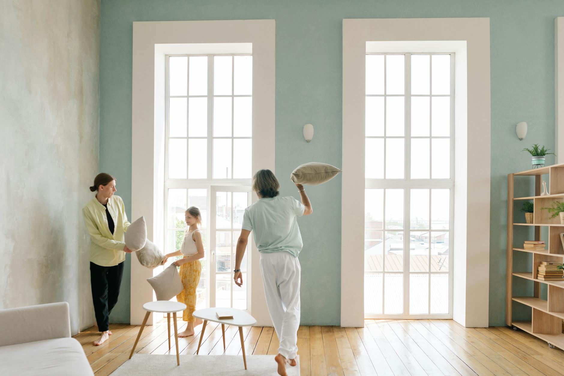A family gathered in a living room with a gaming setup