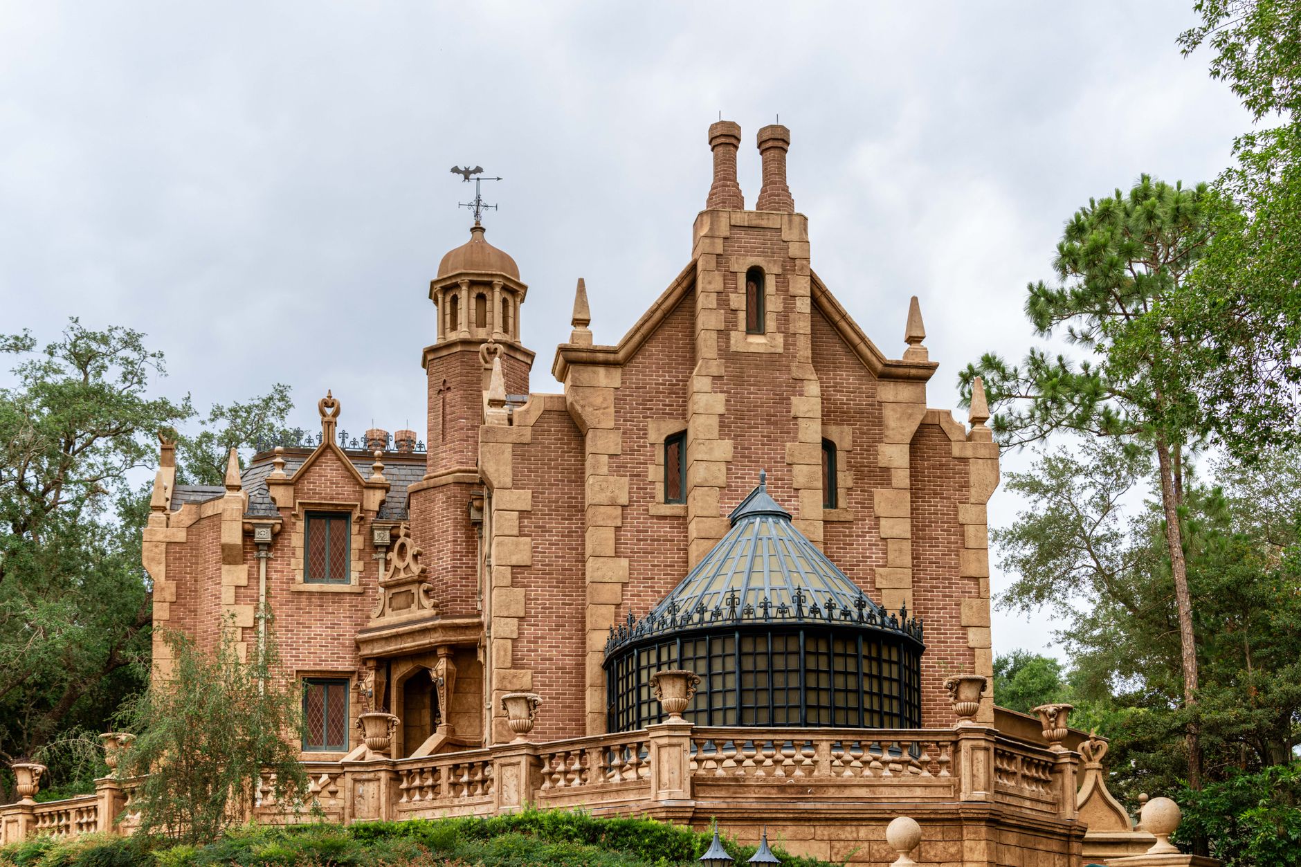 Dark, atmospheric haunted mansion exterior at night suggesting ghost adventure themes