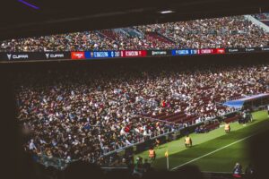 Fans watching an intense soccer match from the stands