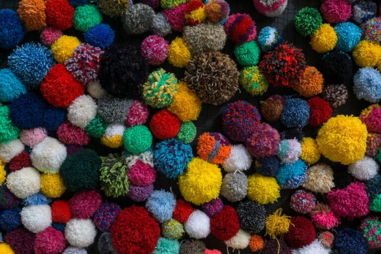 Colorful balls of yarn arranged together, representing the handcrafted aesthetic of Yoshi's Woolly World