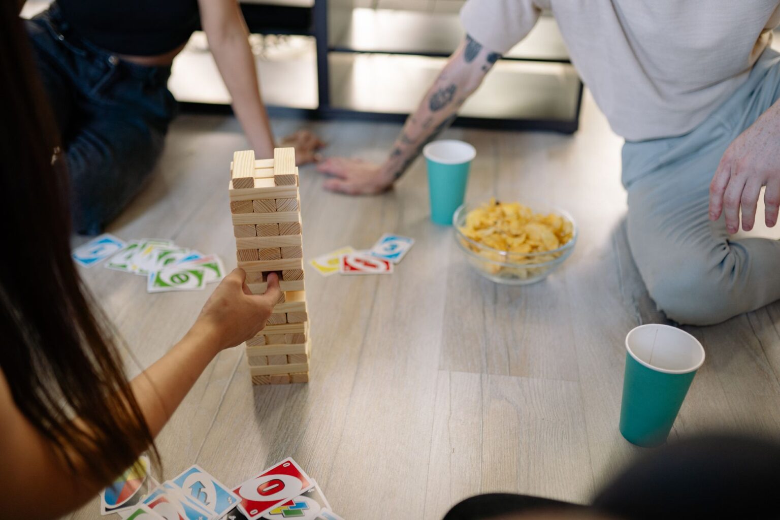 Friends gathered around a board game during a party night