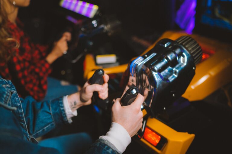 A gaming controller resting beside a television screen showing a colorful racing game