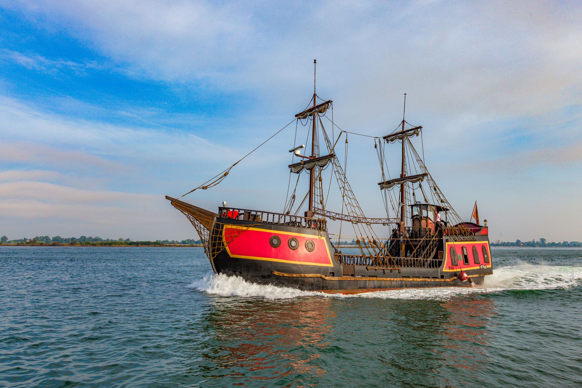 A sailing ship on the open ocean, evoking the Sea of Thieves aesthetic