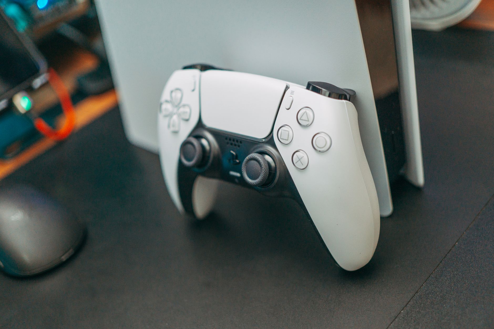 A PlayStation 5 DualSense controller resting on a surface