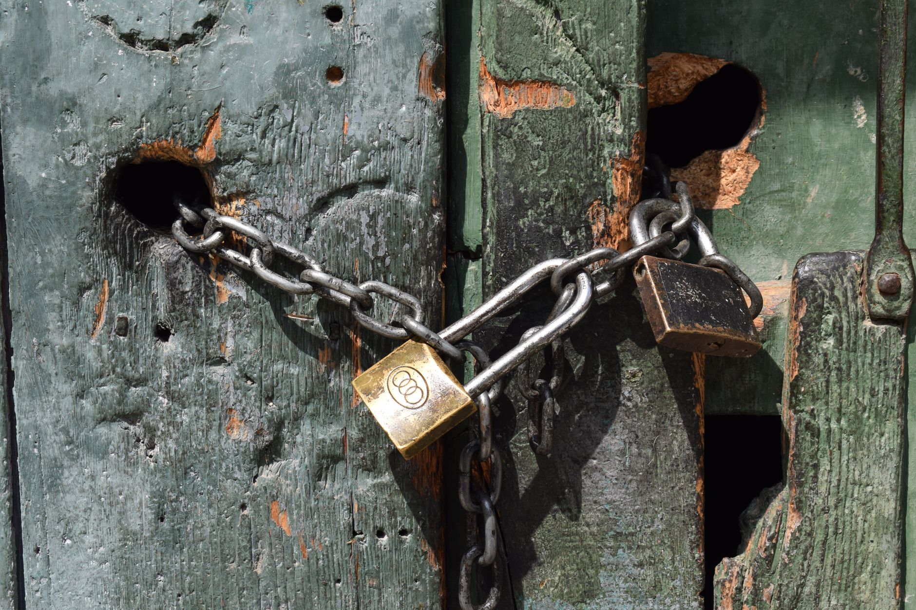 A weathered locked wooden door, representing content locked behind collectible thresholds in Donkey Kong Bananza
