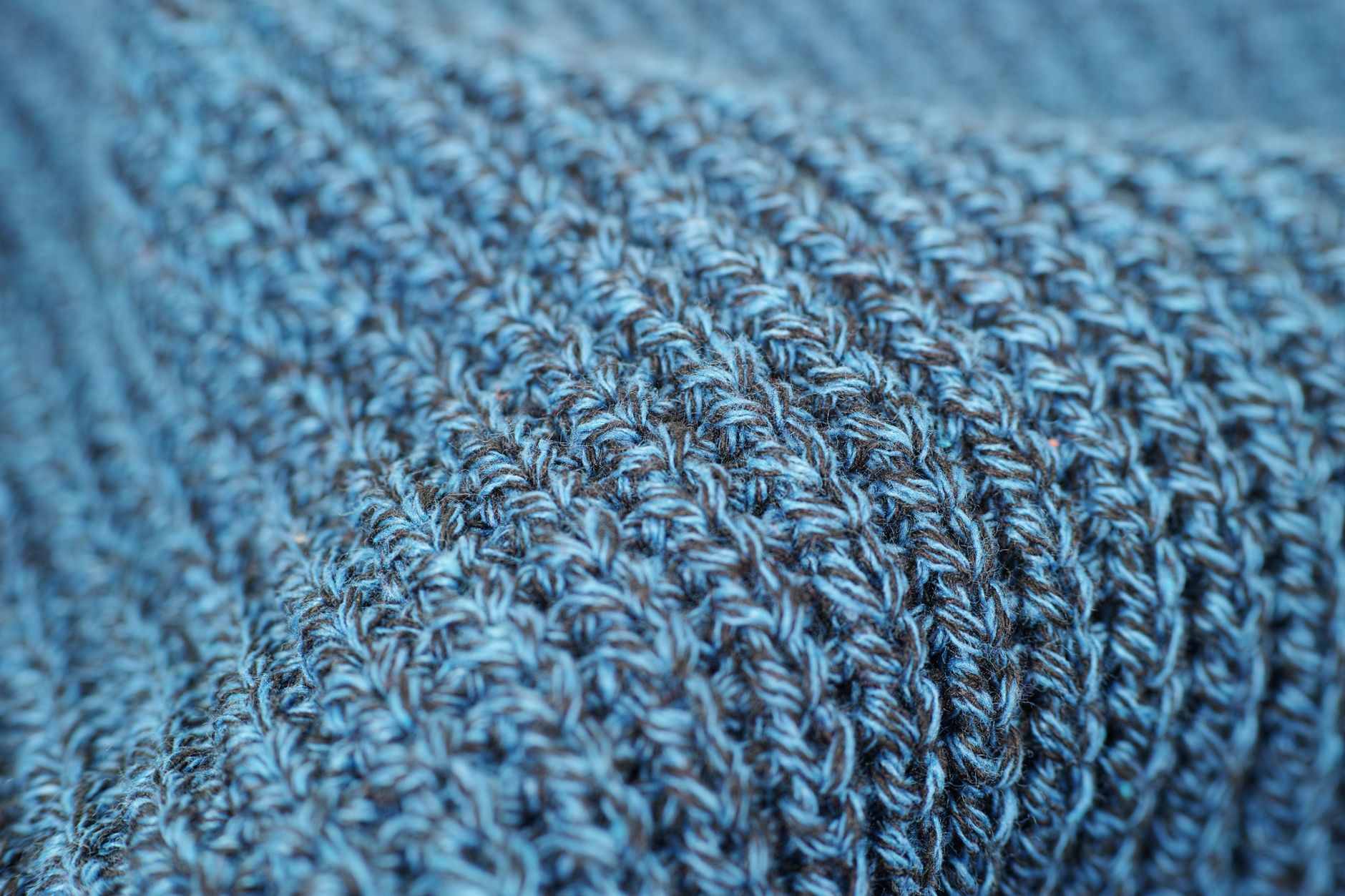 Close-up of soft woven fabric texture, echoing the handmade visual style of the Woolly World franchise