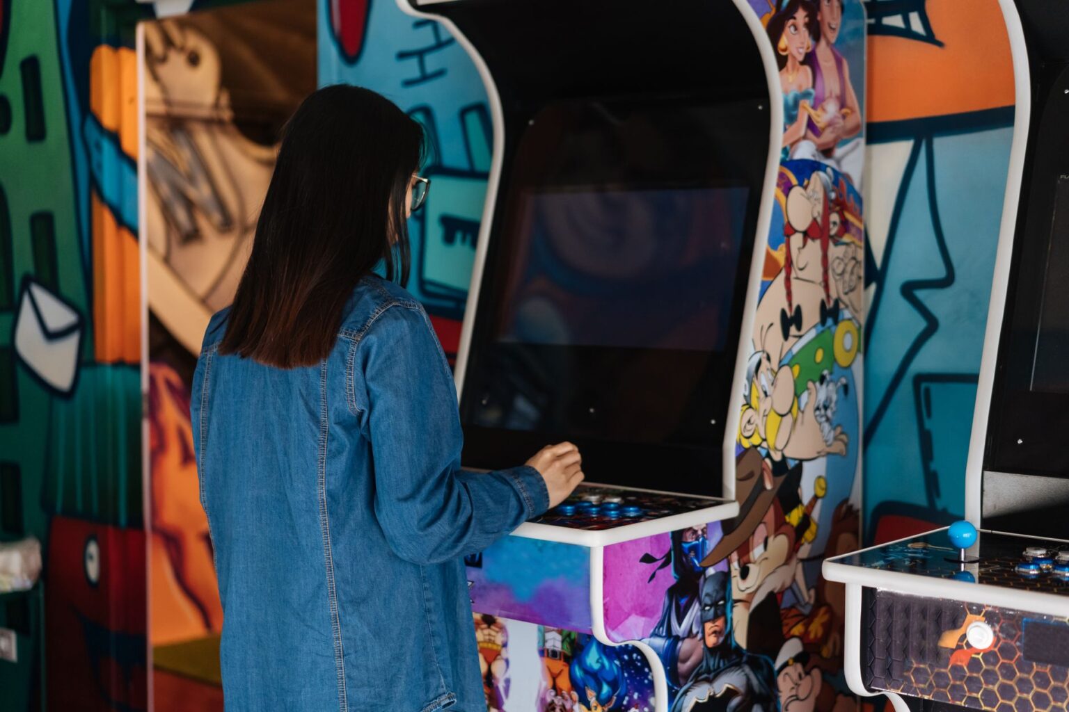 Classic arcade cabinet glowing in a dark room, evoking retro gaming nostalgia