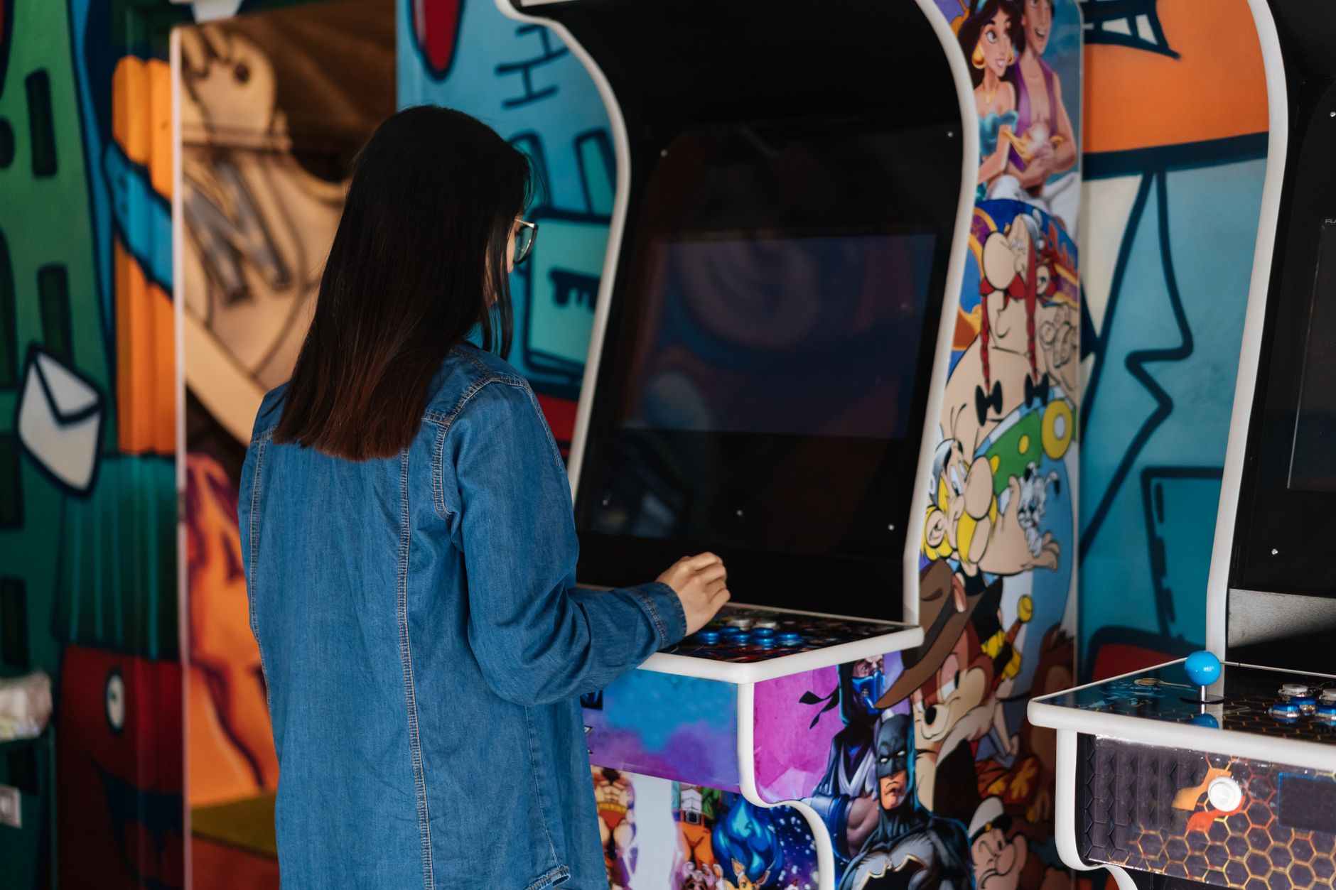 Classic arcade cabinet glowing in a dark room, evoking retro gaming nostalgia