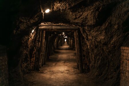 Donkey Kong Bananza’s Mole Miner Overuse Is Quietly Boring Mid-Game Players Dark underground cave environment with rocky walls, resembling a mining setting