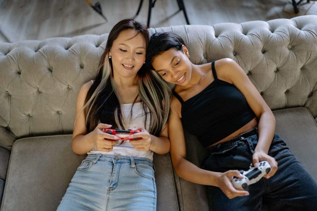 Friends playing a video game together on a couch, representing co-op gaming culture