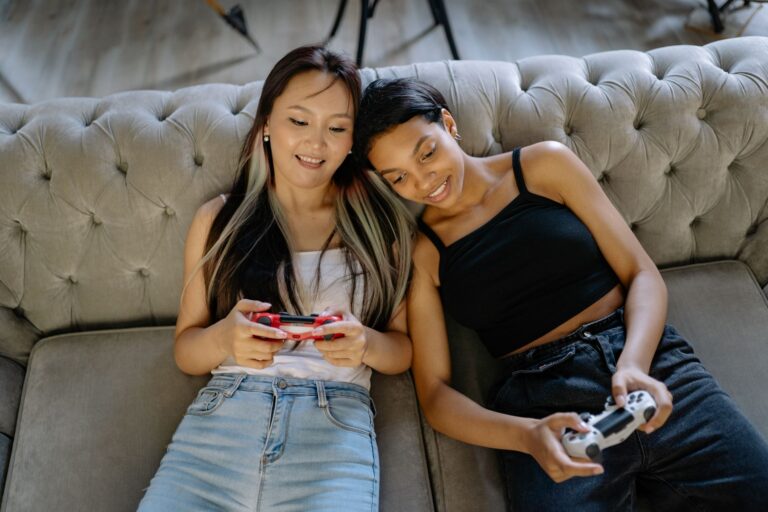Friends playing a video game together on a couch, representing co-op gaming culture