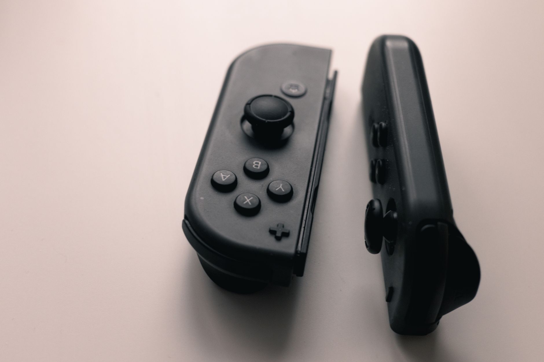 A close-up of a gaming controller resting on a surface, symbolizing console gaming