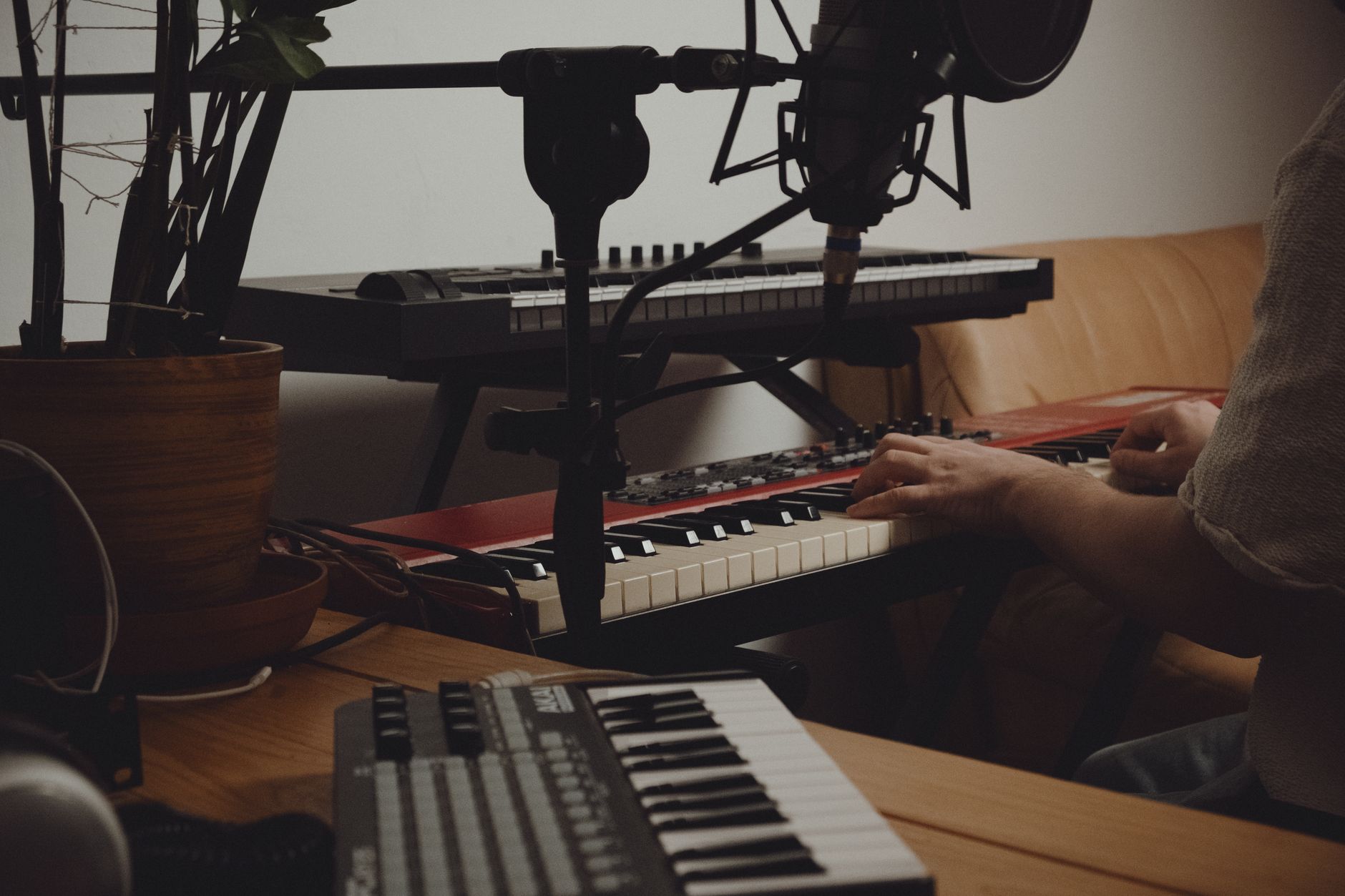 A music composer working at a studio mixing board, representing game soundtrack production