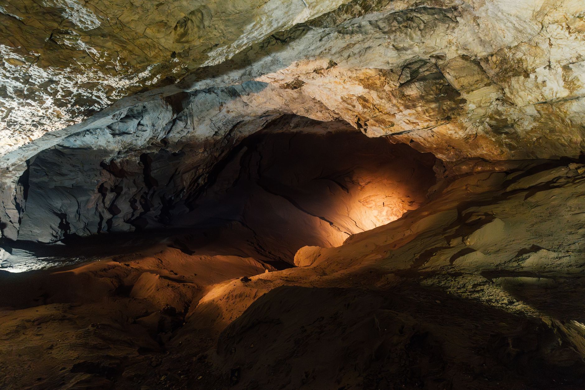 Dark underground cave with rock formations representing subterranean exploration
