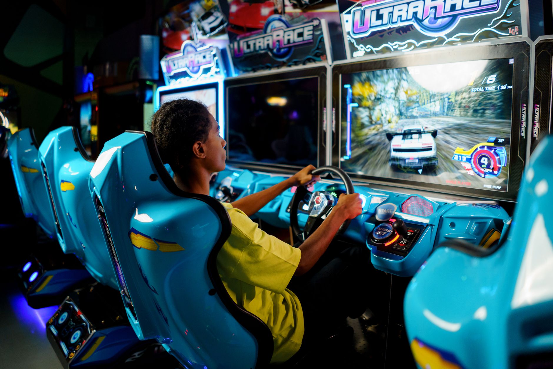 A futuristic racing game displayed on a monitor, evoking fast-paced sci-fi gameplay