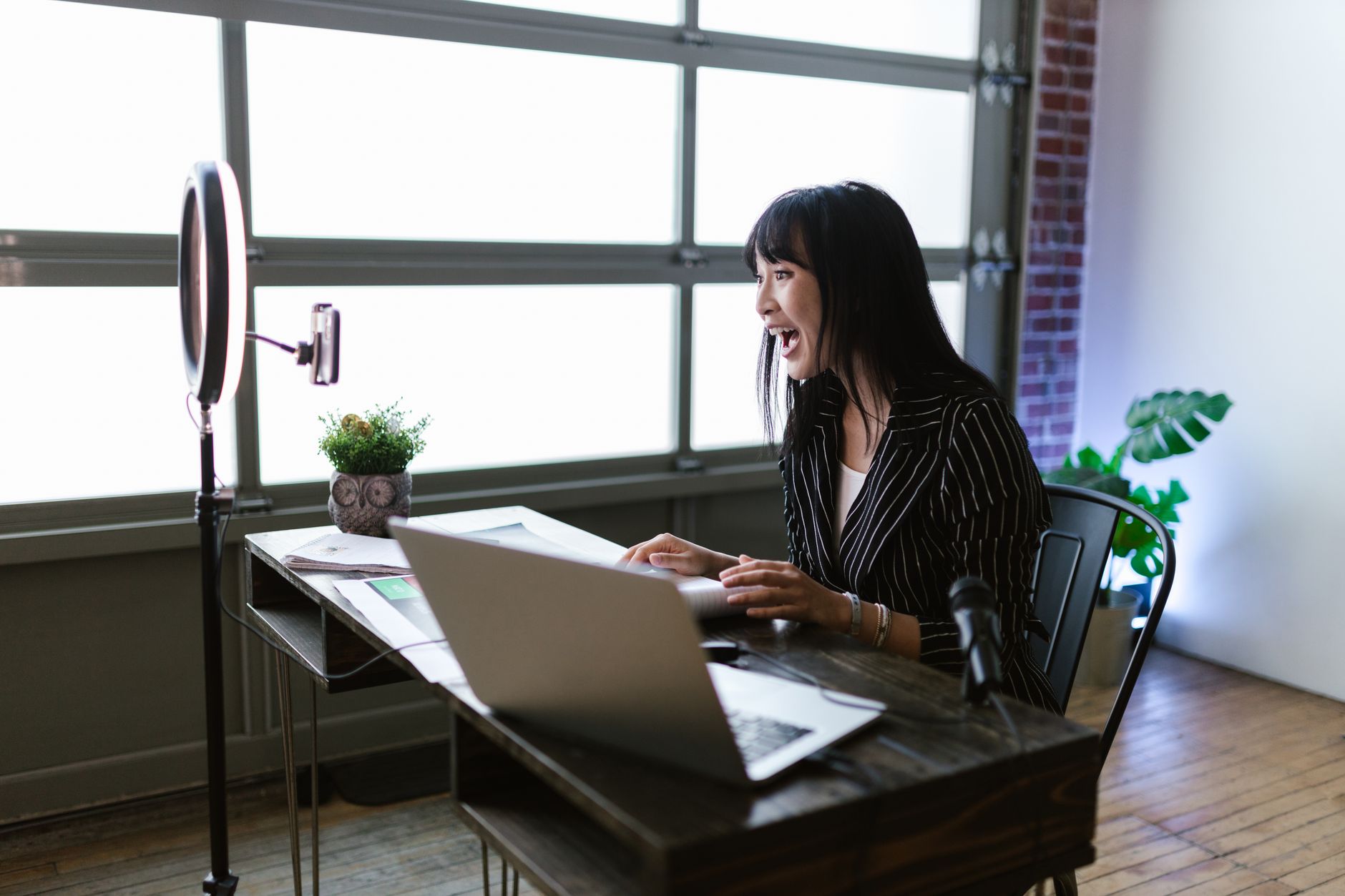 A content creator working at a desk with multiple monitors, editing video game footage for social media