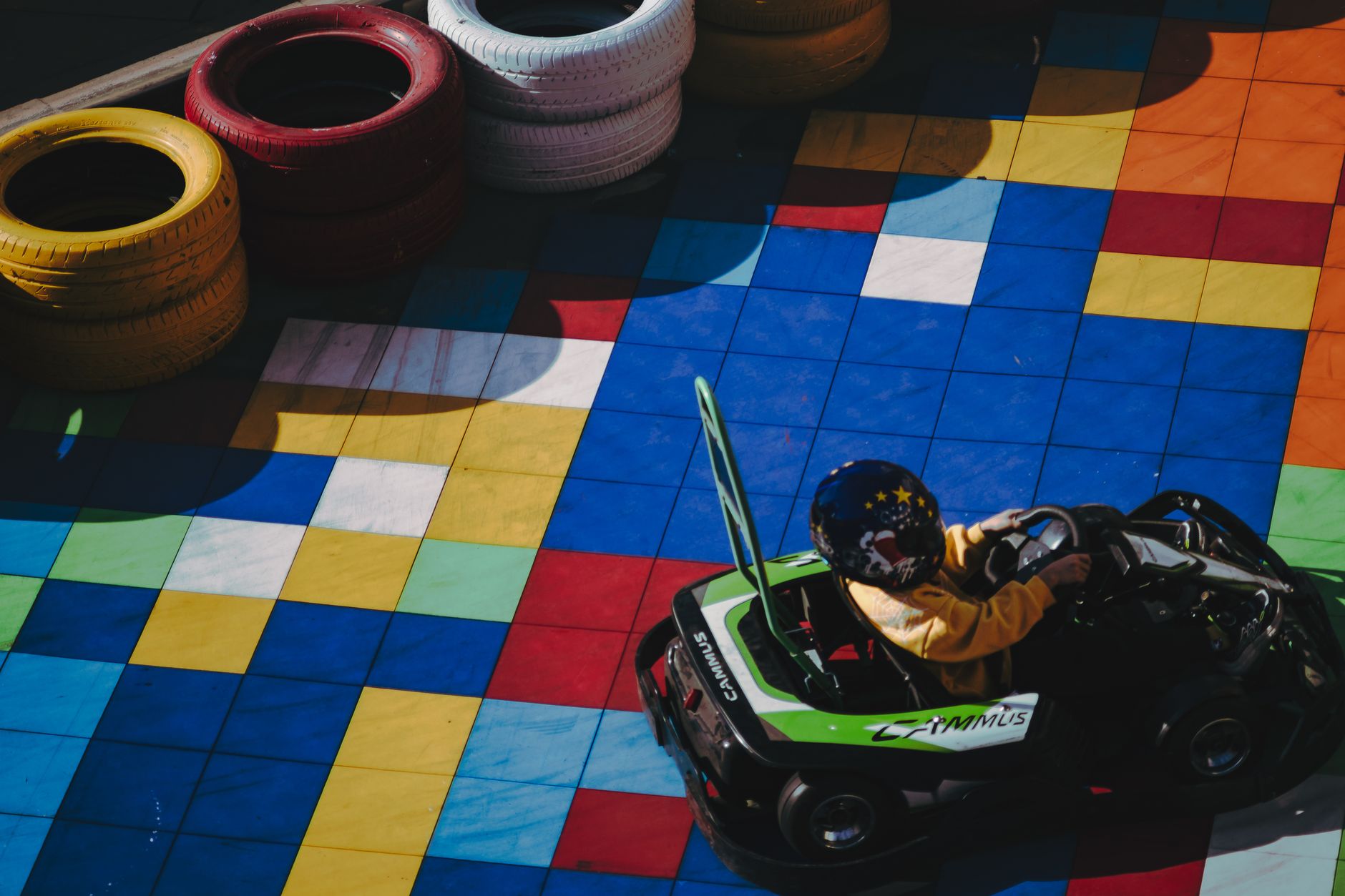 A colorful racing track viewed from above, evoking classic kart racing game aesthetics