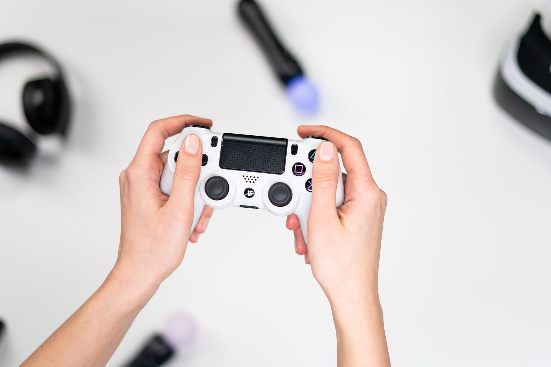 A gamer holding a controller while playing a video game on a television screen