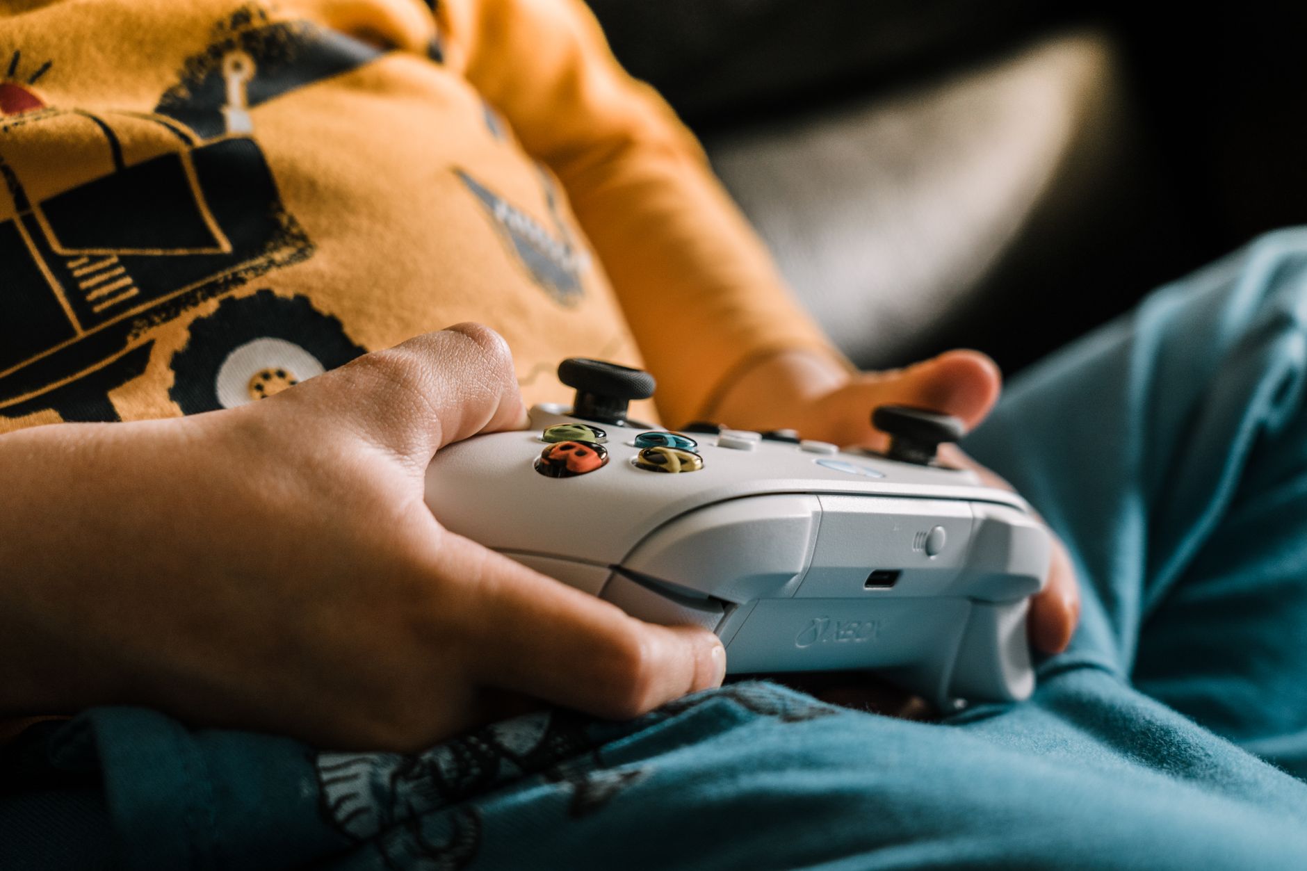 Two young children playing a video game console together at home