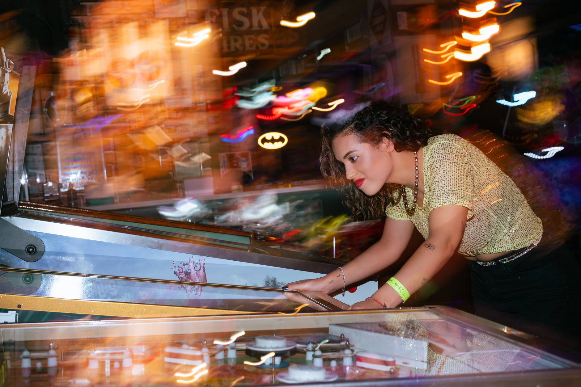 Neon-lit arcade game machines in a darkened room, evoking nostalgic gaming culture