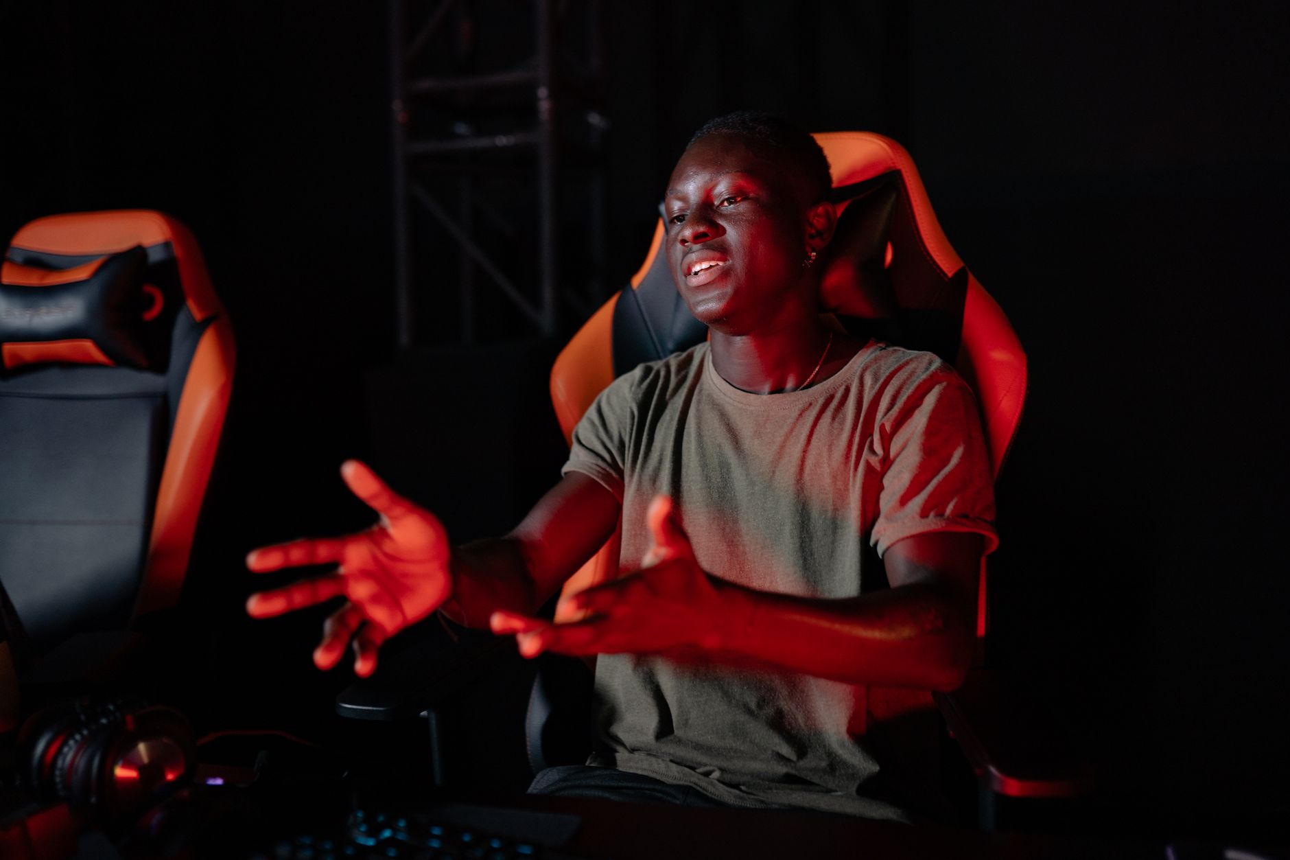 Person at a gaming setup showing signs of fatigue or frustration during extended play