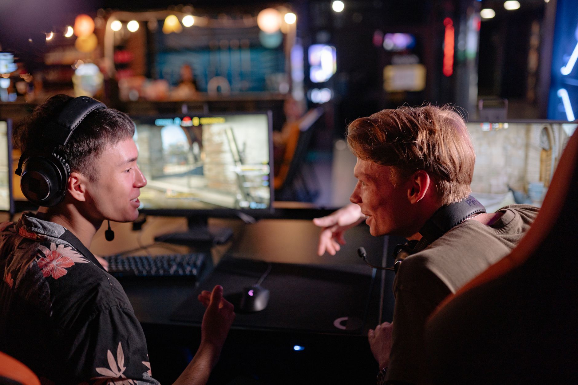 People engaged in discussion around a screen representing fan debate and community conversation