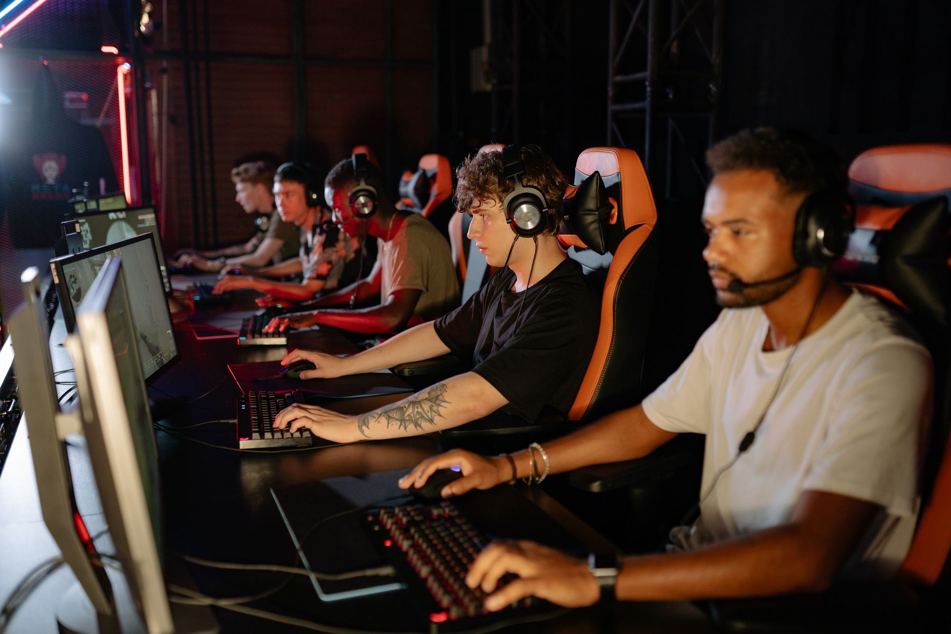 A crowd gathered at an esports event watching competitive gaming on large screens