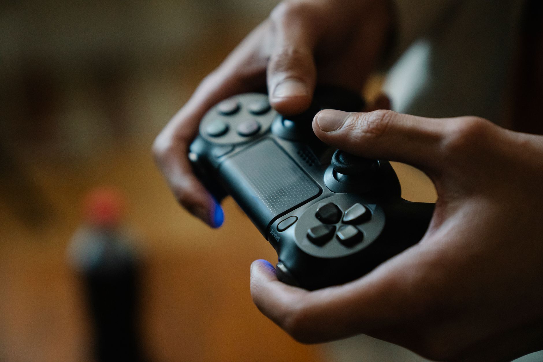 Modern video game controller resting on a surface, symbolizing gaming platform competition