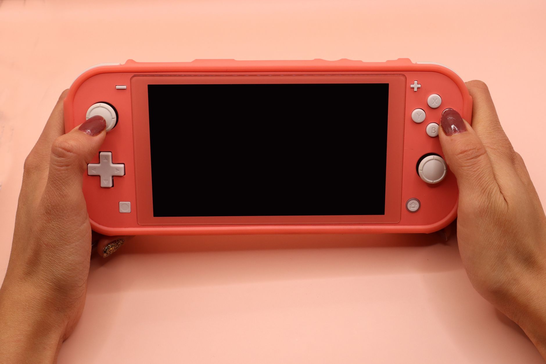A Nintendo Switch console in handheld mode resting on a surface