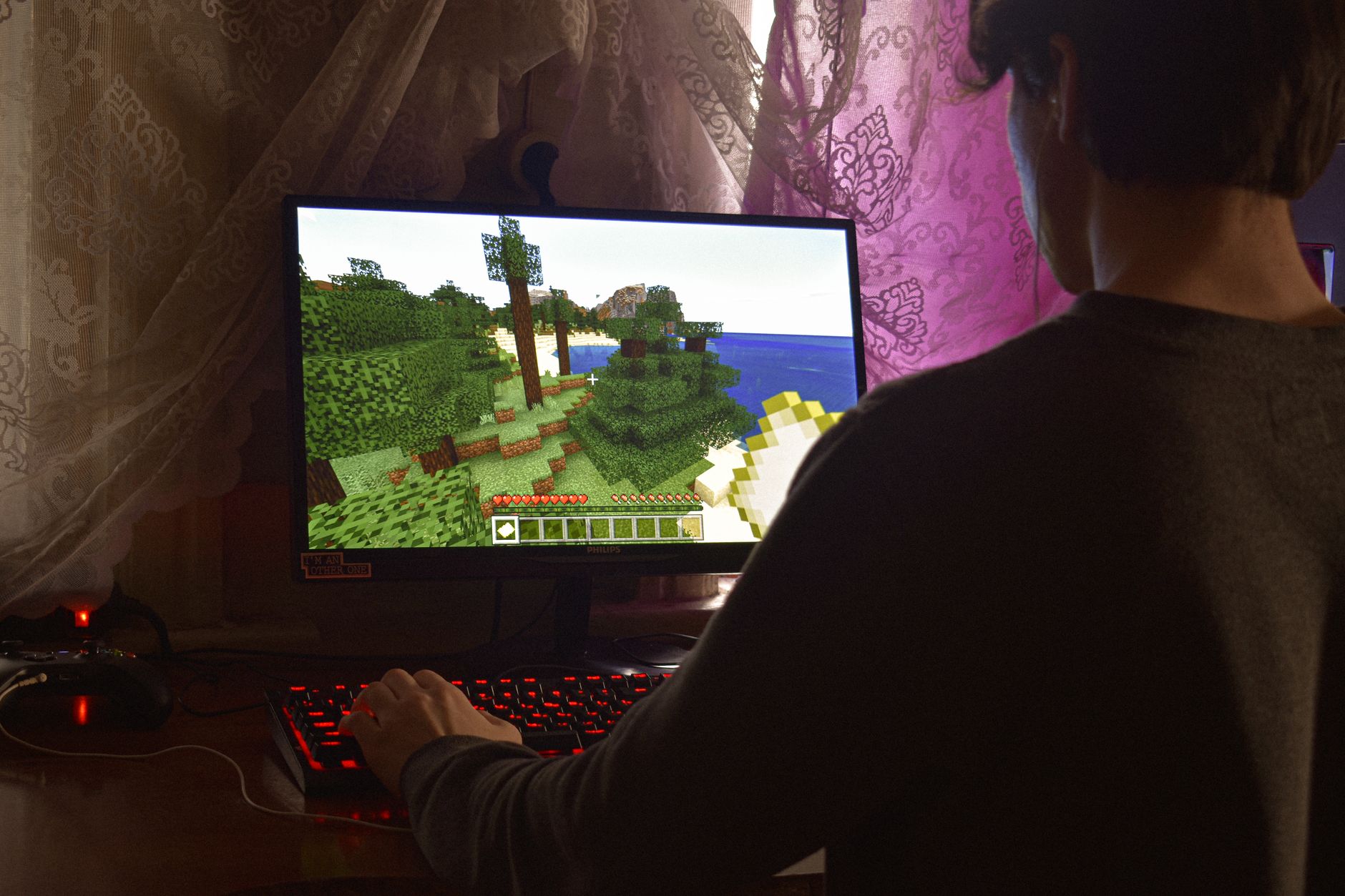 A person playing a video game on screen, representing the completionist gaming experience