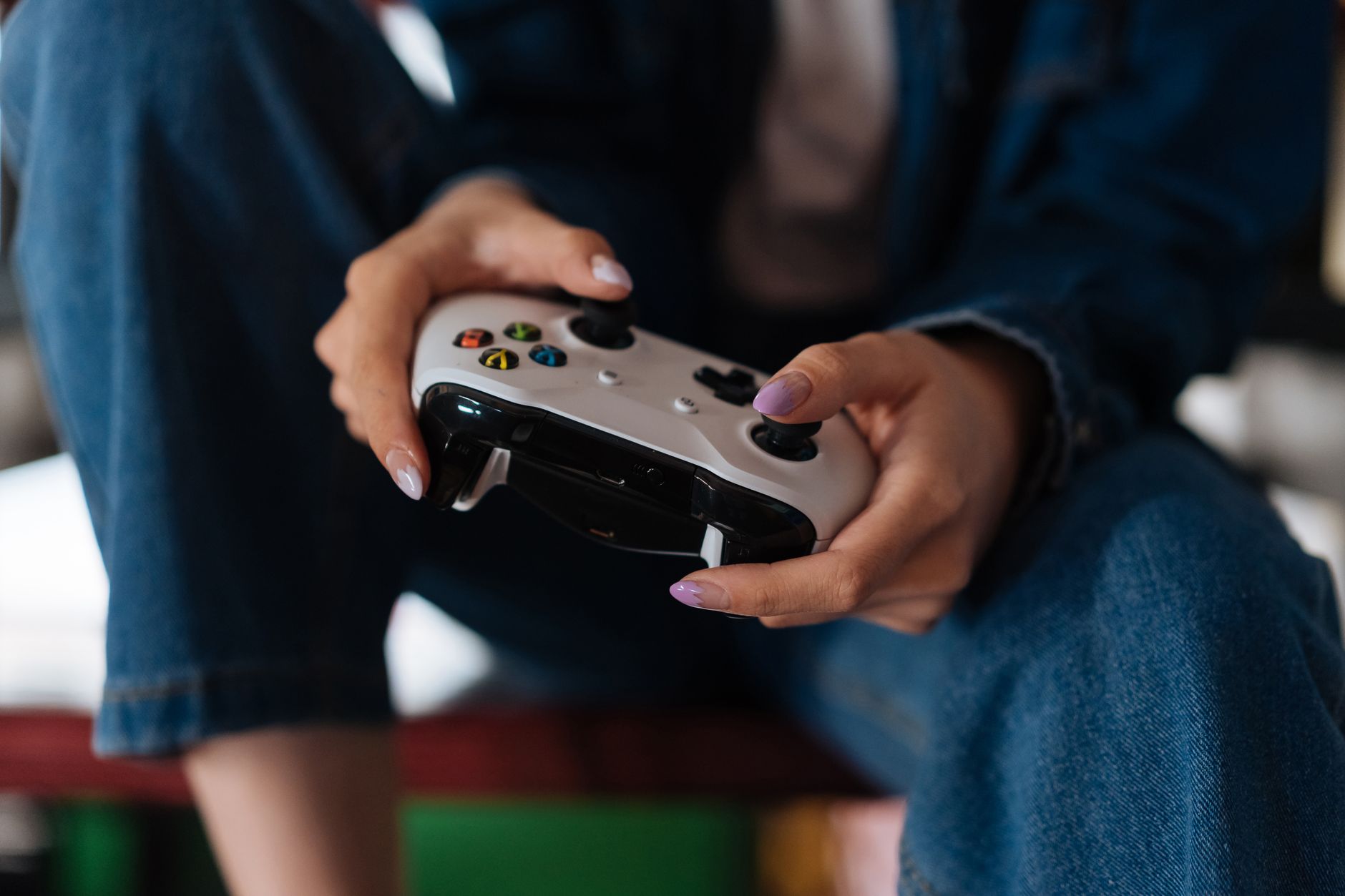 A person playing a video game at home, representing the casual player experience